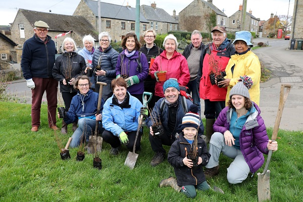 Ovington Tree Planting group holding planting tools and tree saplings