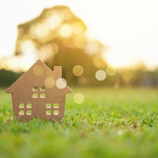 A grass field near a house