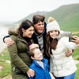 A foster family on a trip in the hills taking a selfie together