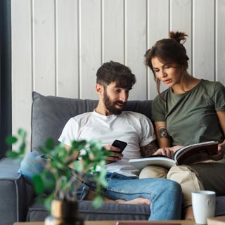 A young couple looking at a info pack