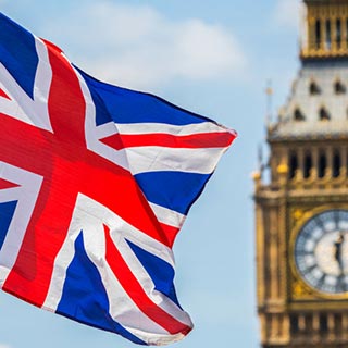 Image of UK flag in from of Parliament building