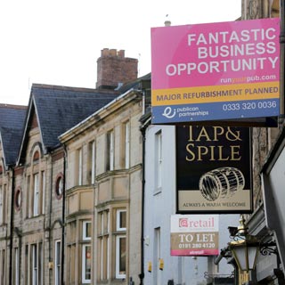 Sale signs about businesses on Hexham street