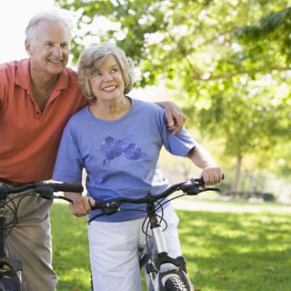 An elderly couple on a bike ride 