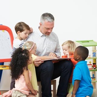 A adult reading a story to a group of children