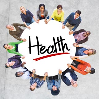 A photo from above of People sitting around a round table with the word Health in the middle