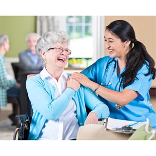 A nurse and an elderly resident having smiling together