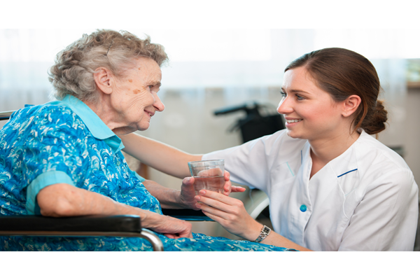 A care worker helping a woman at home