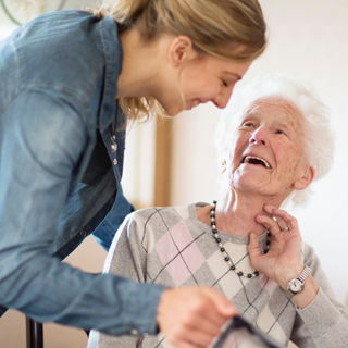 A care worker helping a woman at home 