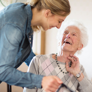 A care worker helping a woman at home