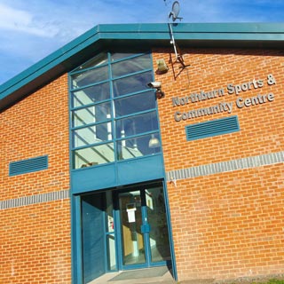 Outside of Northburn Sports and Community centre, a large brick building