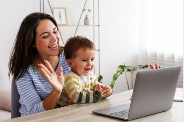 Mum on a laptop with a toddler