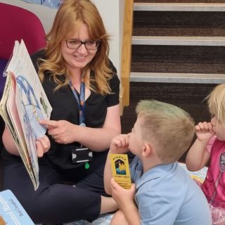 Two young children being read a story