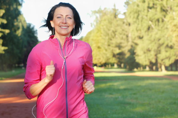 Person running in a park with earphones in