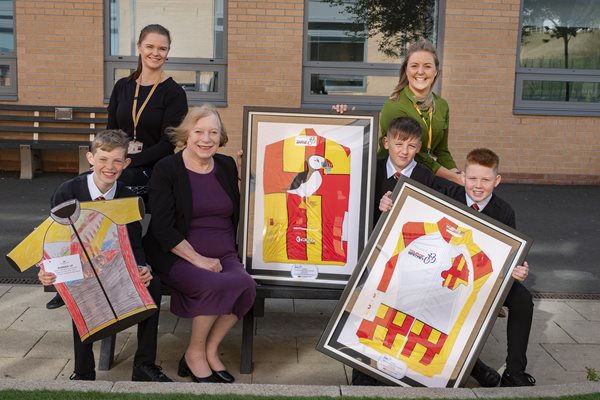 Image demonstrating Winning schools receive their Tour design jerseys 