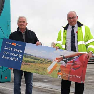 Councillors holding an anti-litter poster