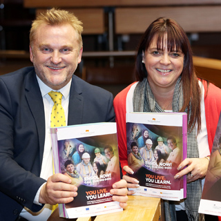 Wayne Daley and Cath McEvoy-Carr holding copies of the new brochure