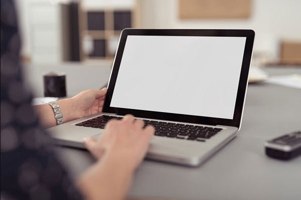 A person using a laptop at a desk