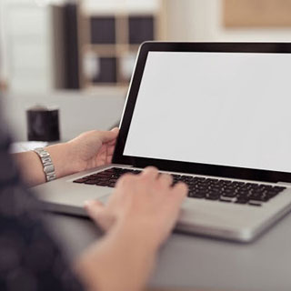 A person using a laptop at a desk