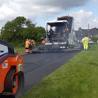 Workers repairing a road