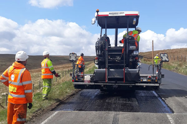 Staff carrying out resurfacing work