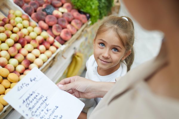 Young girl shopping with parent