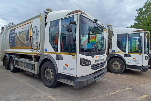 Two bin lorries with Northumberland County Council logos on the side