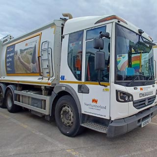 A bin lorry with Northumberland County Council logos on the side