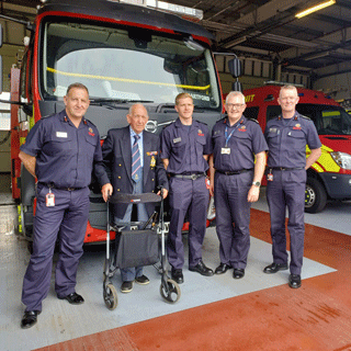 100 year old firefighter with fire personnel 