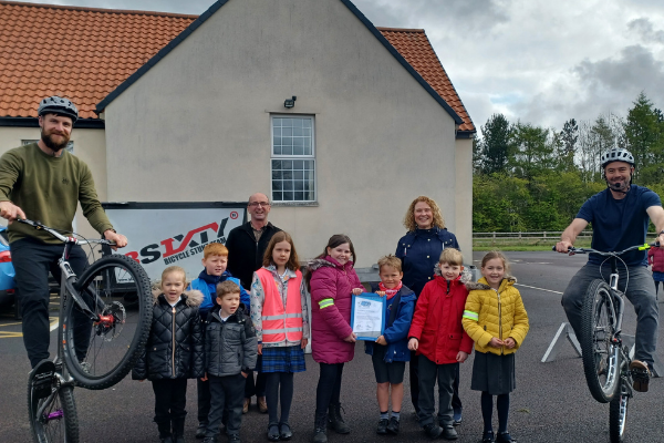 Children from Stannington First School are presented with their ModeShift STARS Platinum Award after a display by bicycle stunt team 3SIXTY 