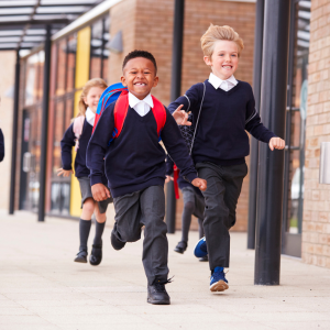 Children excited running towards school 