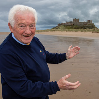 Councillor Jeff Watson celebrates Bamburgh being named the UKs best seaside destination