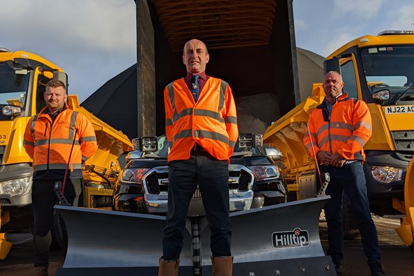 Staff standing by a gritting machine. The council is ready to tacckle problems on the roads caused by snow and ice.