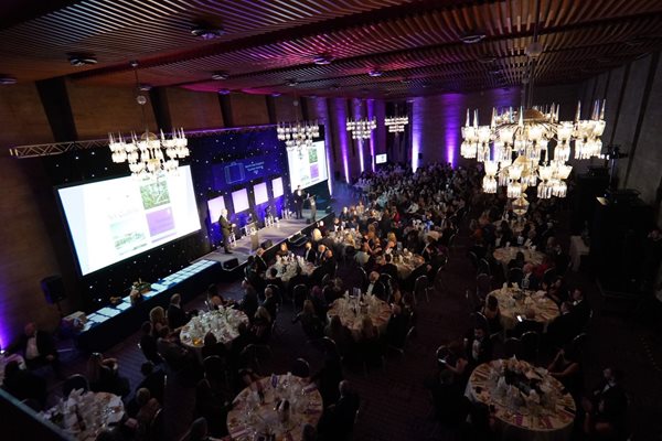 Photo of the North East England Tourism Awards. Round Tables with groups of people sitting at them looking towards a raised stage where winners of awards are being announced.