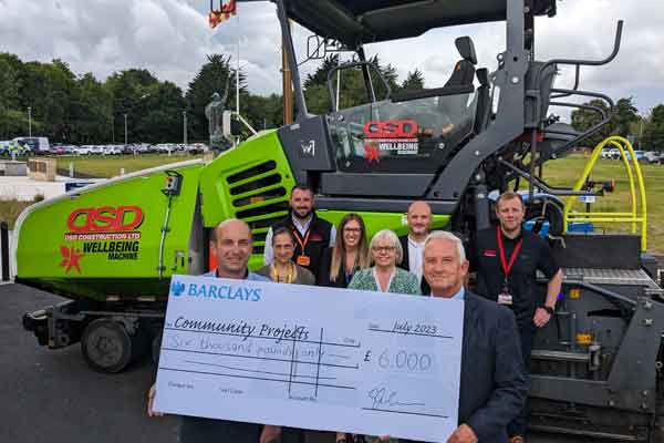 People holding a big cheque to mark the council's contractors giving benefits to the community