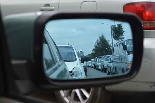 A traffic jam viewed in a rear view mirror