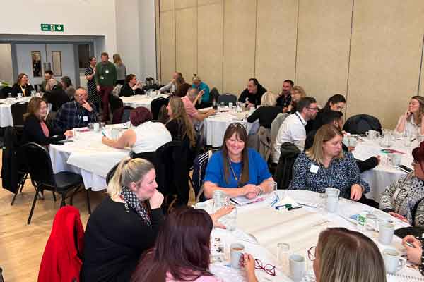 Groups of people discussing employment barriers at Newbiggin