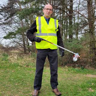 Councillor John Riddle picking litter to promote Keep Britain Tidy's Great British Spring Clean 2023