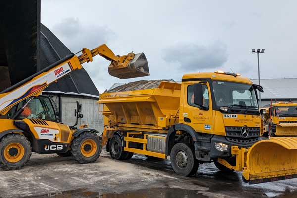 A gritter being loaded with salt