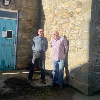 Two councillors outside the old toilets in Hexham which will soon be refurbished