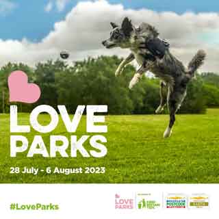 A dog jumping in the air to celebrate Love Parks Week 2023
