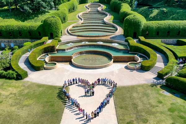 People forming a heart shape at Alnwick Garden