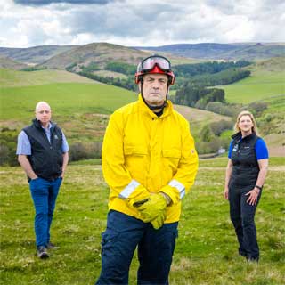 Council staff, fire officers and countryside rangers on a hillside