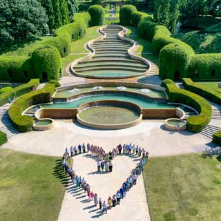 People forming a heart shape at The Alnwick Garden
