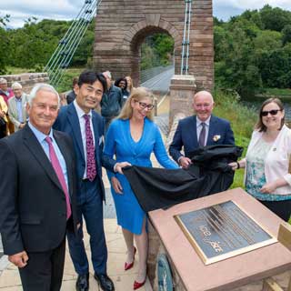 A plaque is unveiled honouring the restoration of the Union Chain Bridge