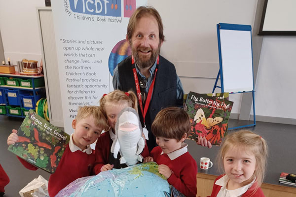 Author, Dom Conlon, with pupils from Abbeyfields First School in Morpeth