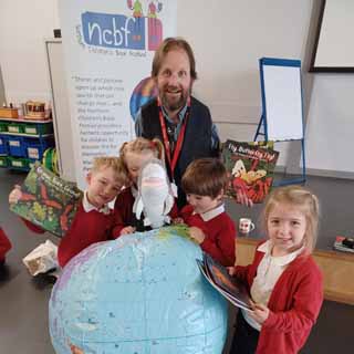 Author, Dom Conlon, with pupils from Abbeyfields First School in Morpeth