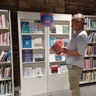 A man browsing books during Green Libraries Week