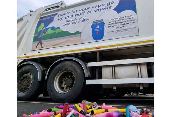 Empty vape containers in front of a bin wagon