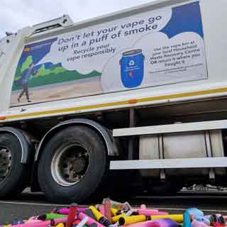 Empty vape containers in front of a bin wagon