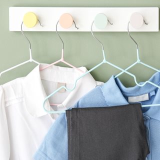 Kids uniform on clothing hangers.